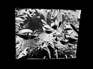 A Piece Of Square Plastic On A Black Background