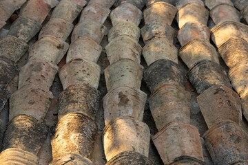 Old tiled roof arranged in parallel rows. Background. Selective focus.