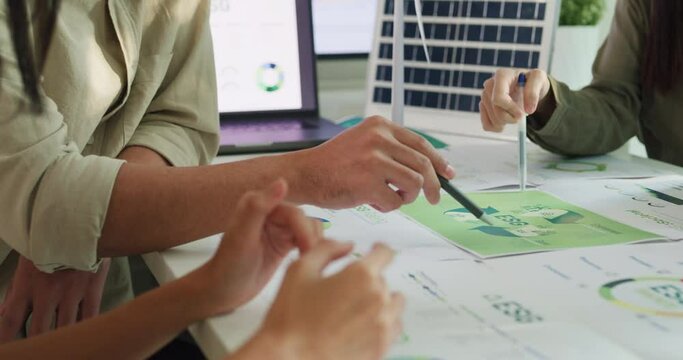 Closeup group Asia businesspeople talk ESG strategies risk management workshop, SDGs report, global warming, green finance investment eco friendly and net zero waste in boardroom training building.