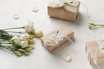 Gift boxes with beautiful roses and petals on white background. International Women's Day