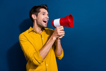 Photo portrait of handsome young guy scream loudspeaker announce wear trendy yellow outfit isolated...