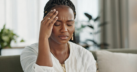 Headache, stress and young black woman in the living room of her modern apartment on weekend....