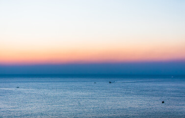 Obraz premium Dawn scenery of the sea. Fishing boats departing early in the morning