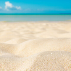 Close-up of white sand on the beach with blue sky background