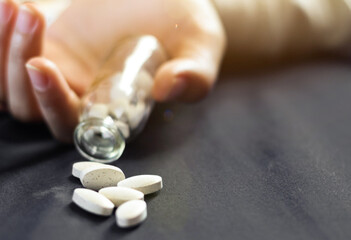 pills in hand,overdose teenager holding bottle and pills coming out of bottle,overdose...