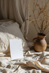 Fototapeta na wymiar Bed With White Sheet and Vase With Plant