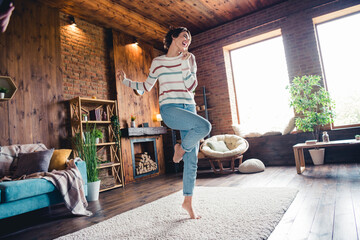 Full body photo of crazy positive lady have fun dancing comfy carpet barefoot modern apartment...
