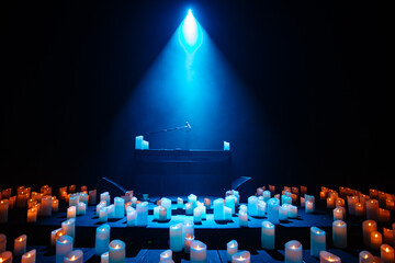 piano on stage with lots of candles
