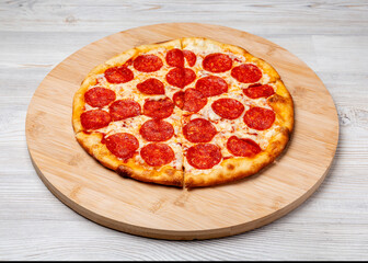 Italian pepperoni pizza on a wooden board