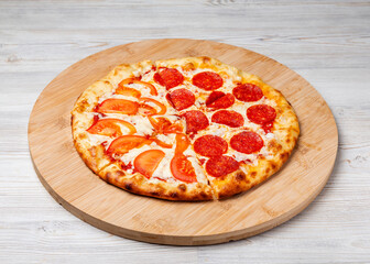 Italian pizza Margherita and Pepperoni on a wooden board