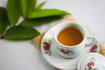Guava leaf tea in a white cup isolated on White background, herbal drink for diarrhea and...