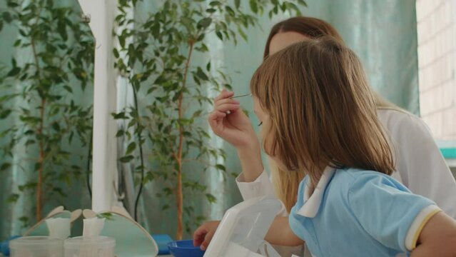 A child's speech journey: fun games, letters, with therapist in white. Office echoes with growth, happy learning.