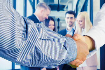 Businessmen making handshake with partner,