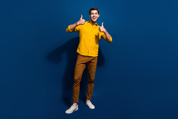 Full size photo of attractive young man show thumb up good quality wear trendy yellow clothes...
