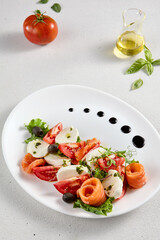Salmon and mozzarella Caprese salad with fresh tomatoes, top view. Ideal for culinary magazines and healthy eating blogs