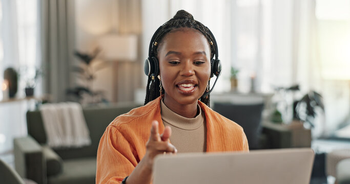 Black woman, headset with laptop and phone call, virtual assistant or crm in home office. Remote work girl at desk with computer, typing and conversation for advice, online chat and help in apartment