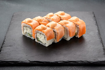 Baked Philadelphia sushi rolls with spicy sauce, offering a creamy and tangy taste in each bite