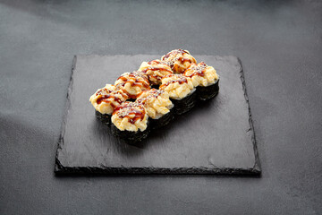 Sushi roll with sea scallop and unagi sauce; a decadent combination of ocean flavor and sweet glaze