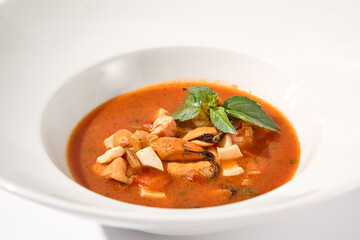 Classic Italian style tomato soup with seafood on white, suited for gourmet blogs and cookbook illustrations
