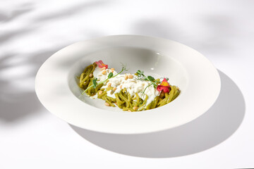 Spaghetti with Pesto Sauce and Stracciatella Cheese, Shadow of a Leaf on White, Ideal for Seasonal...
