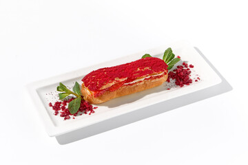 Raspberry eclair on an isolated white background, elegantly presented with a dusting of red powder