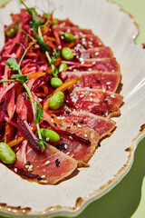 Close-up of tuna tataki with julienne vegetables and sesame seeds, a macro showcase of healthy gourmet dining