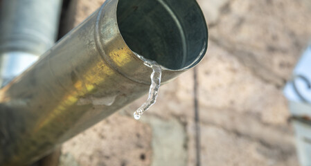 Hanging icicles on the edge of the pipe.