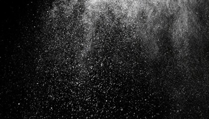 Abstract splashes of water on a black background. Freeze motion of white particles. Rain, snow...