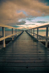 wooden pier on the sea at sunset time