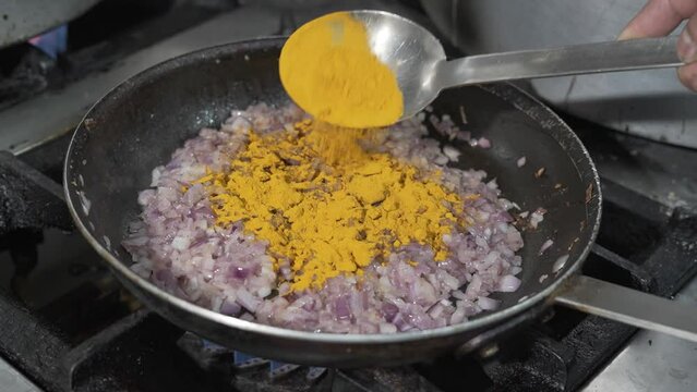 Adding Turmeric to Saut&eacute;ed Onions in Pan