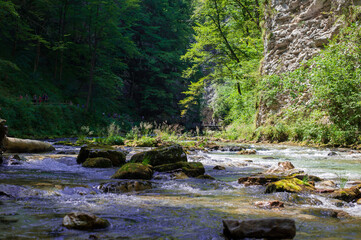 turquoise crystal clear water of a waterfall of a mountain Alpine river
