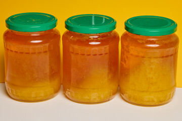 Jar of natural honey made at home on a table.