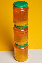 Jar of natural honey made at home on a table.