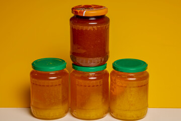 Jar of natural honey made at home on a table.