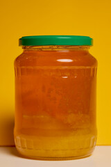 Jar of natural honey made at home on a table.
