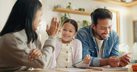 High five, girl with parents and support with learning in house with card, game or mom and dad...
