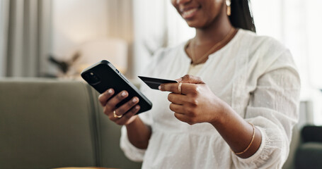 Hands, woman and credit card with smartphone on sofa for online shopping, payment and fintech at...