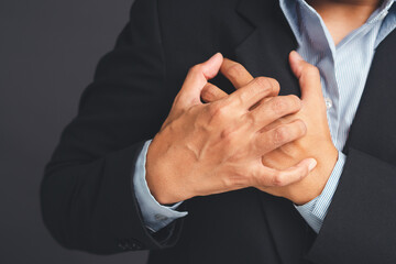 Businessman suffering from chest pain, closeup of male hands.