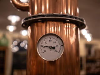 Thermometer at copper distillery still - obrazy, fototapety, plakaty