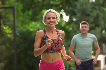 Fototapeta premium Happy young couple running together