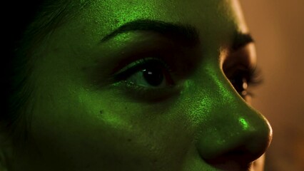 Close up on woman's eyes as she reacts and flinches to something she sees on screen