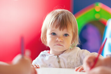 Cute baby girl drawing