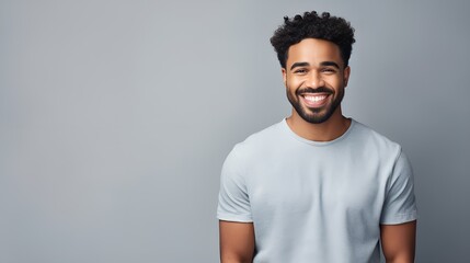 Person in casual attire smiling in a plain background setting , person, casual attire, smiling, plain background