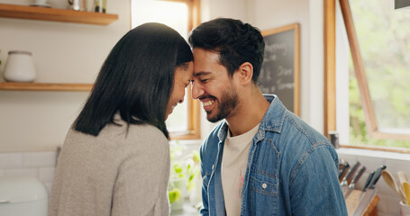 Love, hug and happy couple in a kitchen talking, together and intimate while bonding in their home....