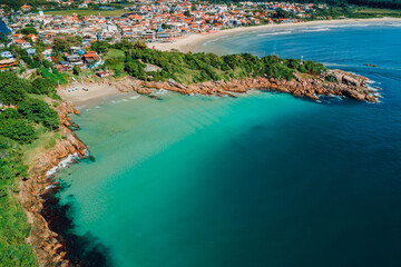 Beach with rocks and ocean in Brazil. Drone view of coastline beach in Florianopolis