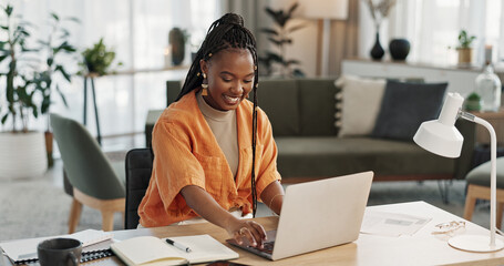 Black woman, typing in home office and laptop for research in remote work, social media or blog in...