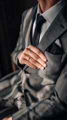 Close-up of a groom getting ready for his wedding day. Wedding ring, groom's hand close up