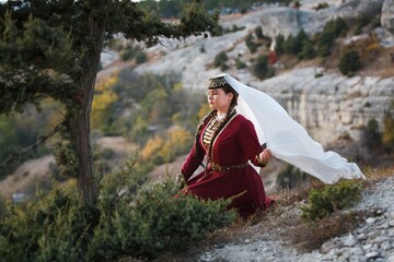 Young muslim woman in tradition hijab on mount background