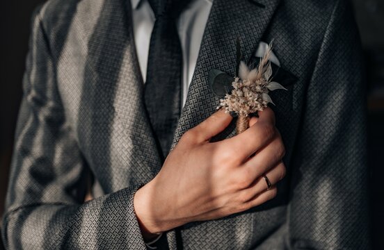 Close-up of a groom getting ready for his wedding day. Wedding ring, groom's hand close up