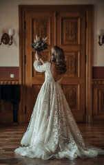 Beautiful bride in rustic boho wedding dress posing
